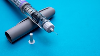 Insulin Pen uncapped with needle exposed.